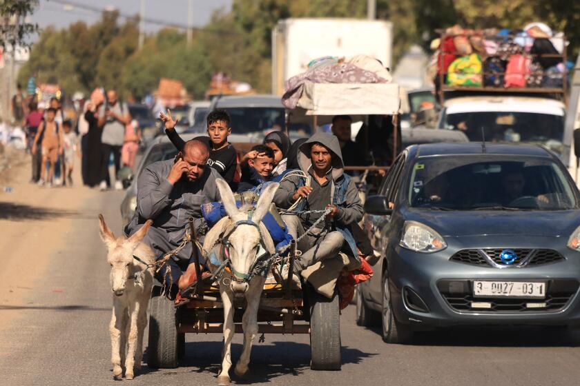 TOPSHOT - Riding a donkey drawn cart as family along with hundreds of other Palestinian carrying their belongings flee following the Israeli army's warning to leave their homes and move south before an expected ground offensive, in Gaza City on October 13, 2023. Palestinians carried belongings through the rubble-strewn streets of Gaza City on October 13, in search of refuge as Israel's army warned residents to flee immediately before an expected ground offensive in retaliation against Hamas for the deadliest attack in Israeli history. (Photo by MAHMUD HAMS / AFP) (Photo by MAHMUD HAMS/AFP via Getty Images)