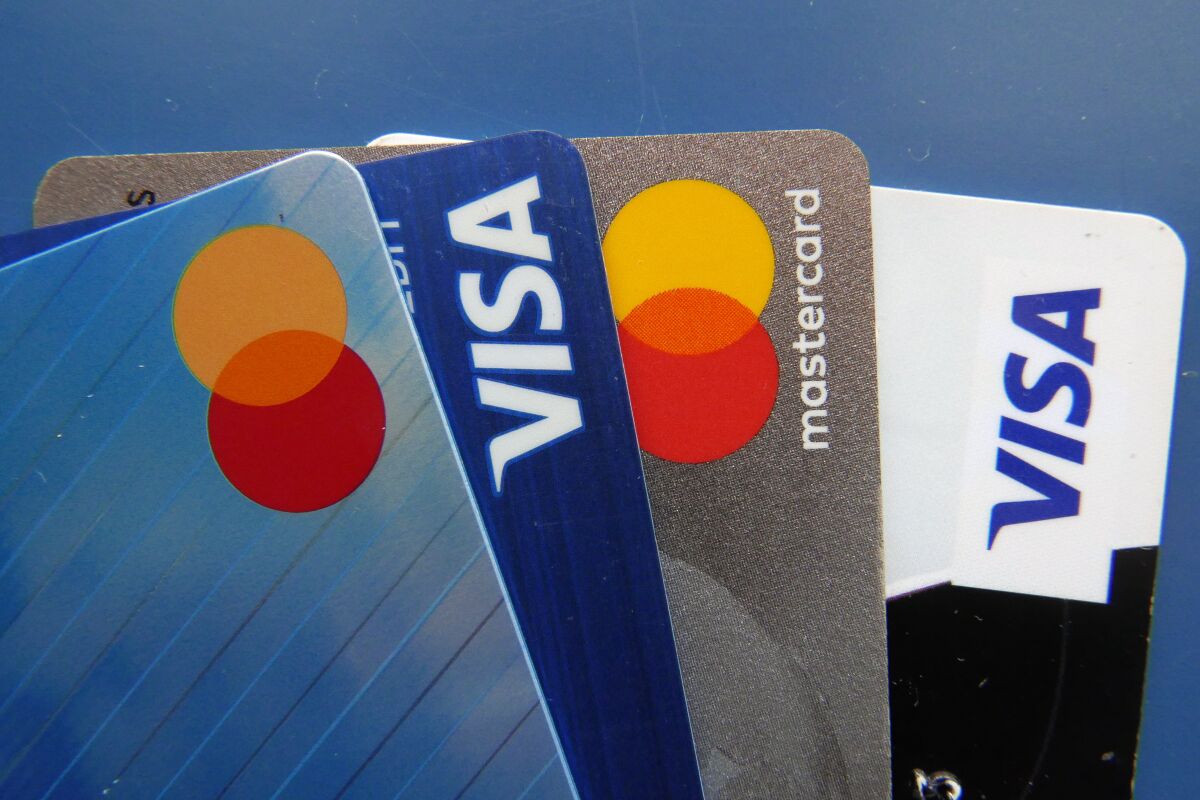 File - Credit cards as seen July 1, 2021, in Orlando, Fla. A low credit score can hurt your ability to take out a loan, secure a good interest rate, or increase a credit card spending limit. (AP Photo/John Raoux, File)