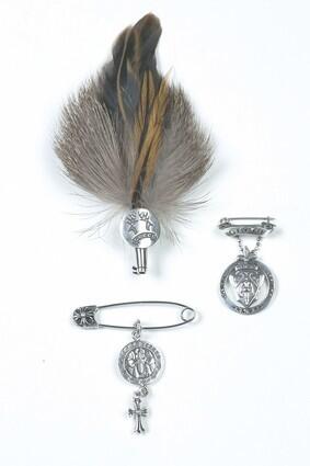 Chrome Hearts angel charm, left, $355, with safety pin, $125, at Chrome Hearts, L.A.; Gucci feather lapel pin, $430; Gucci lapel pin, above, $320, at Gucci, Beverly Hills.