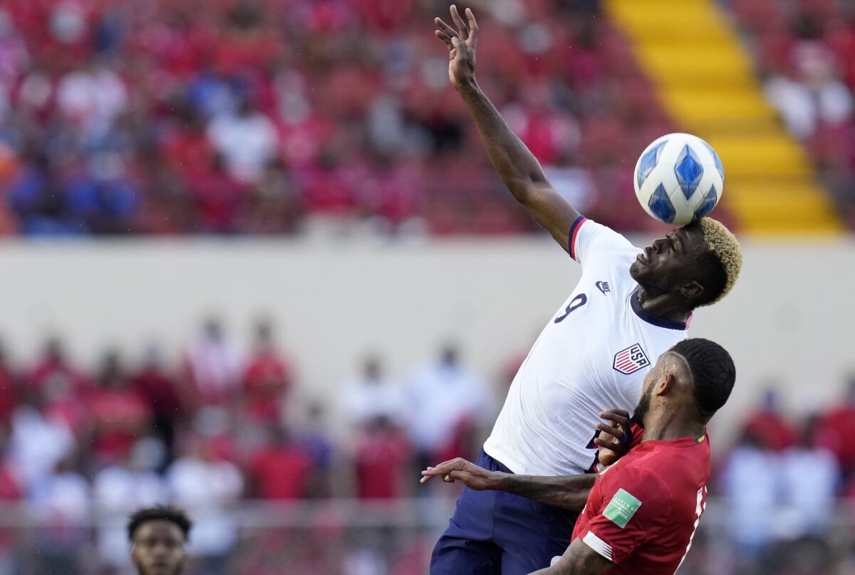 United State´s Gyasi Zardes, top, and Panama's Eric Davis head for the ball during a qualifying soccer match for the FIFA World Cup Qatar 2022 at Rommel Fernandez stadium, Panama city, Panama, Sunday, Oct. 10, 2021. (AP Photo/Arnulfo Franco)