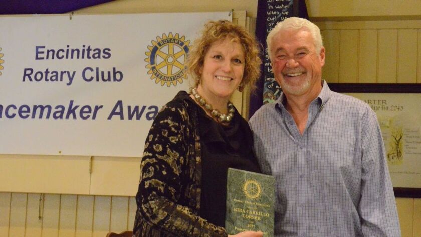 Peacemaker award recipient Kira Carrillo Corser poses alongside Greg Day, president of the Encinitas Rotary Club, after receiving the distinction.