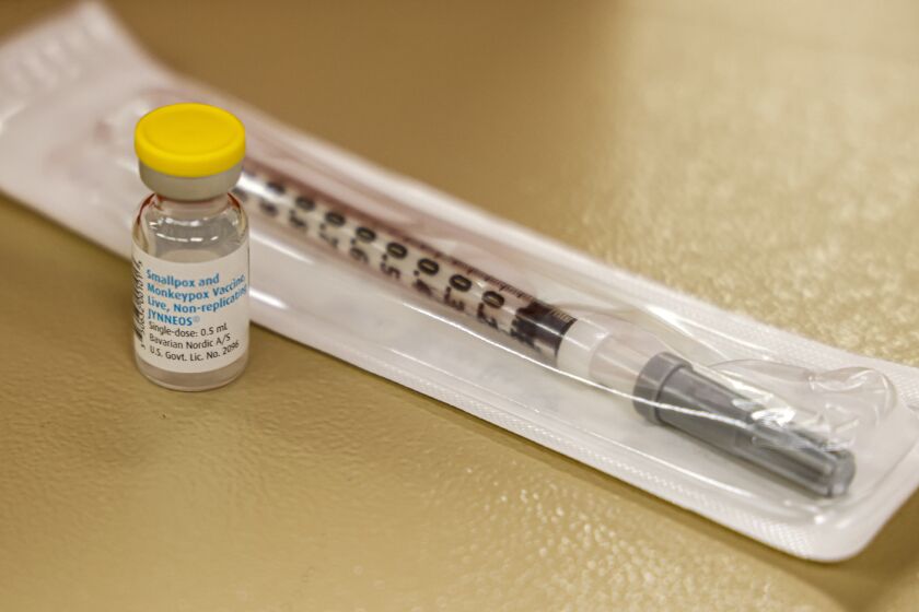 FILE - A vial containing the monkeypox vaccine and a syringe is set on the table at a vaccination clinic run by the Mecklenburg County Public Health Department in Charlotte, N.C., Saturday, Aug. 20, 2022. At-risk people who received just one dose of the monkeypox vaccine appeared to be significantly less likely to get sick from the virus, public health officials announced Wednesday, even as they urged a second dose for full protection. (AP Photo/Nell Redmond, File)