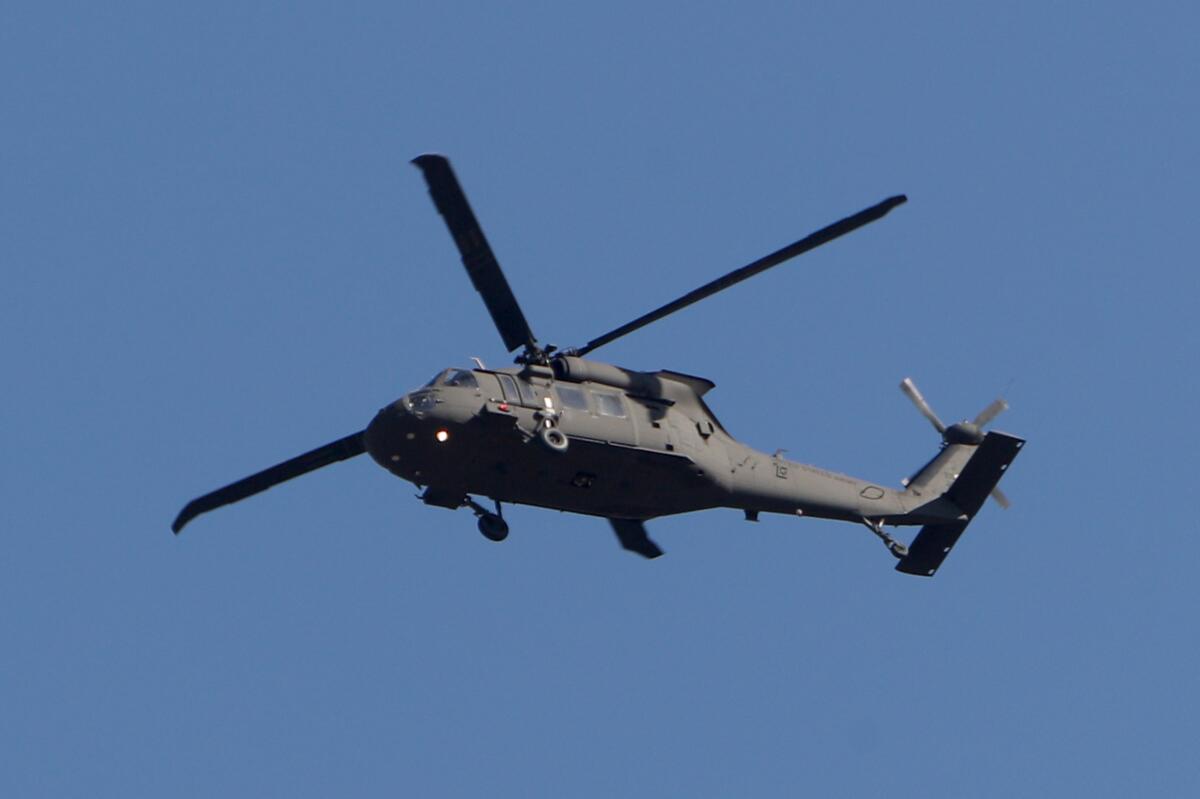 A Blackhawk helicopter flying overhead.