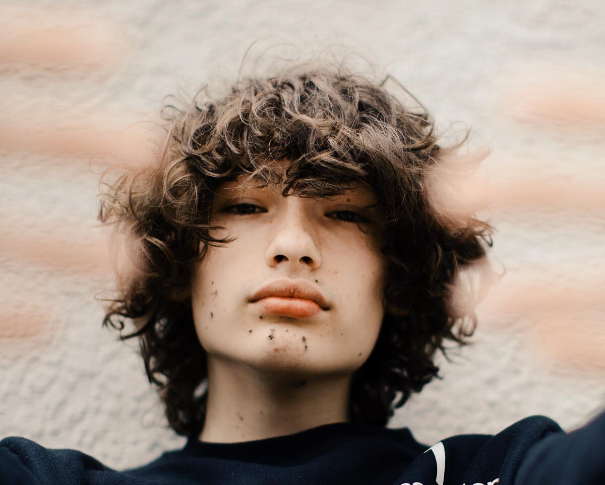 Close-up of a teenage boy's face and floppy hair