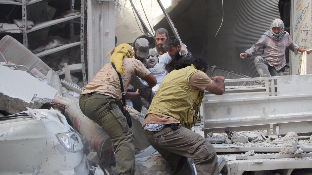 A person is evacuated from the rubble following a reported air strike in the rebel-held city of Idlib in Syria on Sept 10, 2016.