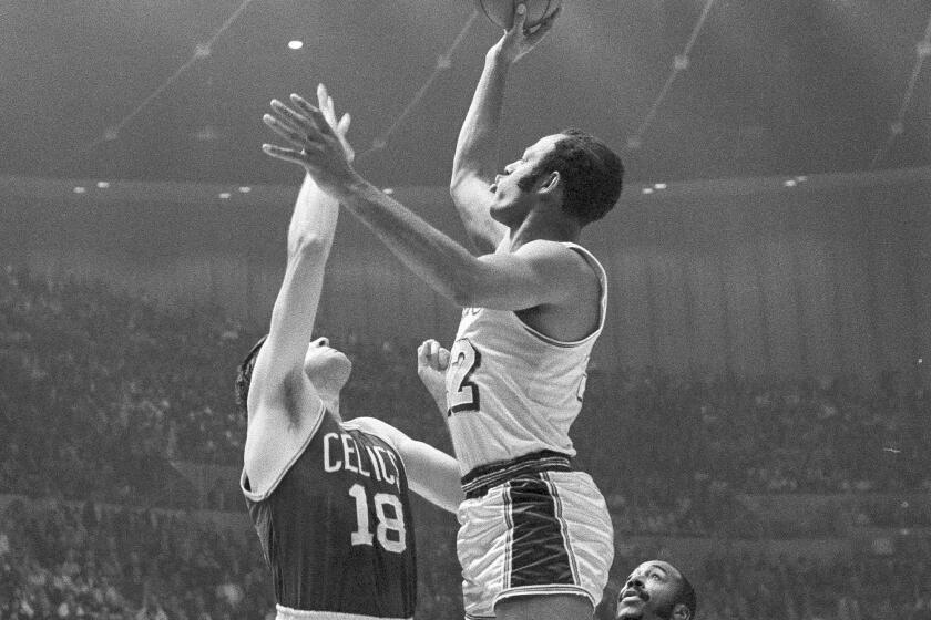 Lakers forward Elgin Baylor elevates for a shot over Celtics forward Bailey Howell during a playoff game on May 5, 1969.