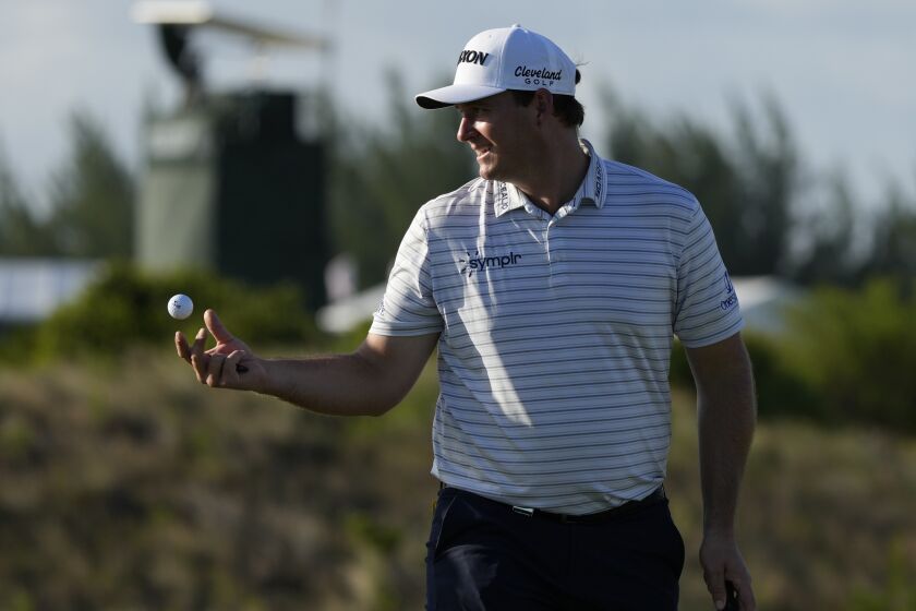 Sepp Straka, of Austria, tosses a ball to his caddie during the first round of the Hero World Challenge PGA Tour at the Albany Golf Club, in New Providence, Bahamas, Thursday, Dec. 1, 2022. (AP Photo/Fernando Llano)