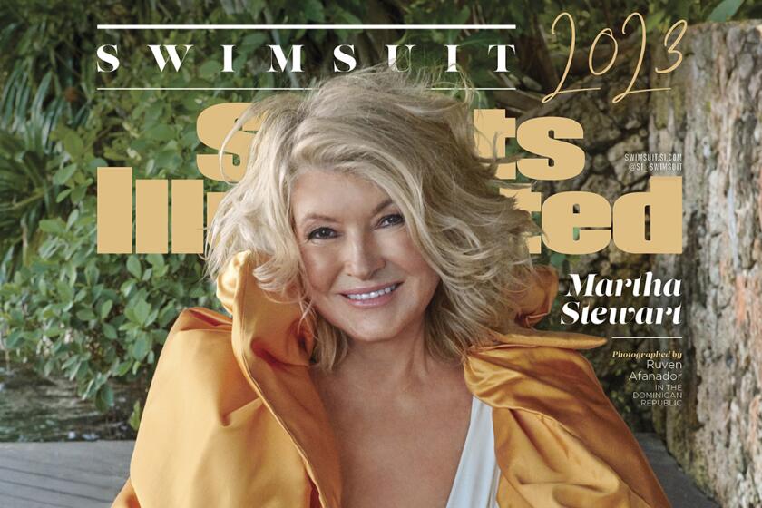 Martha Stewart poses on the cover of Sports Illustrated in a white swimsuit and gold cover-up.