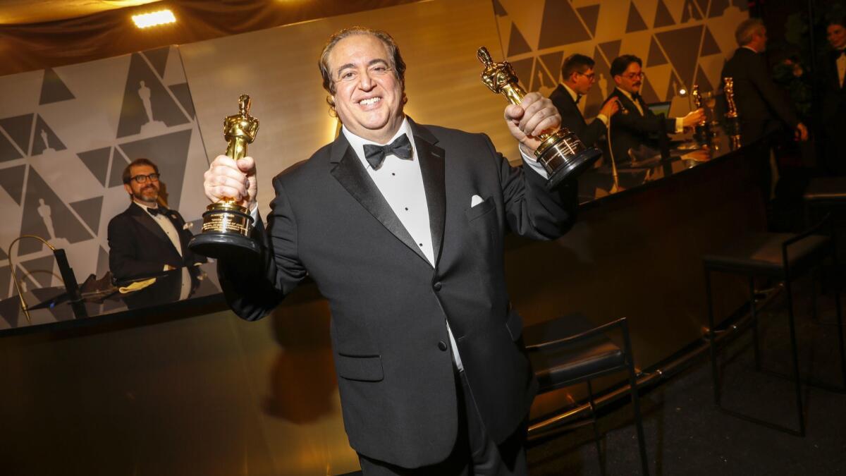 Nick Vallelonga hoists his Oscars for "Green Book": best picture and original screenplay