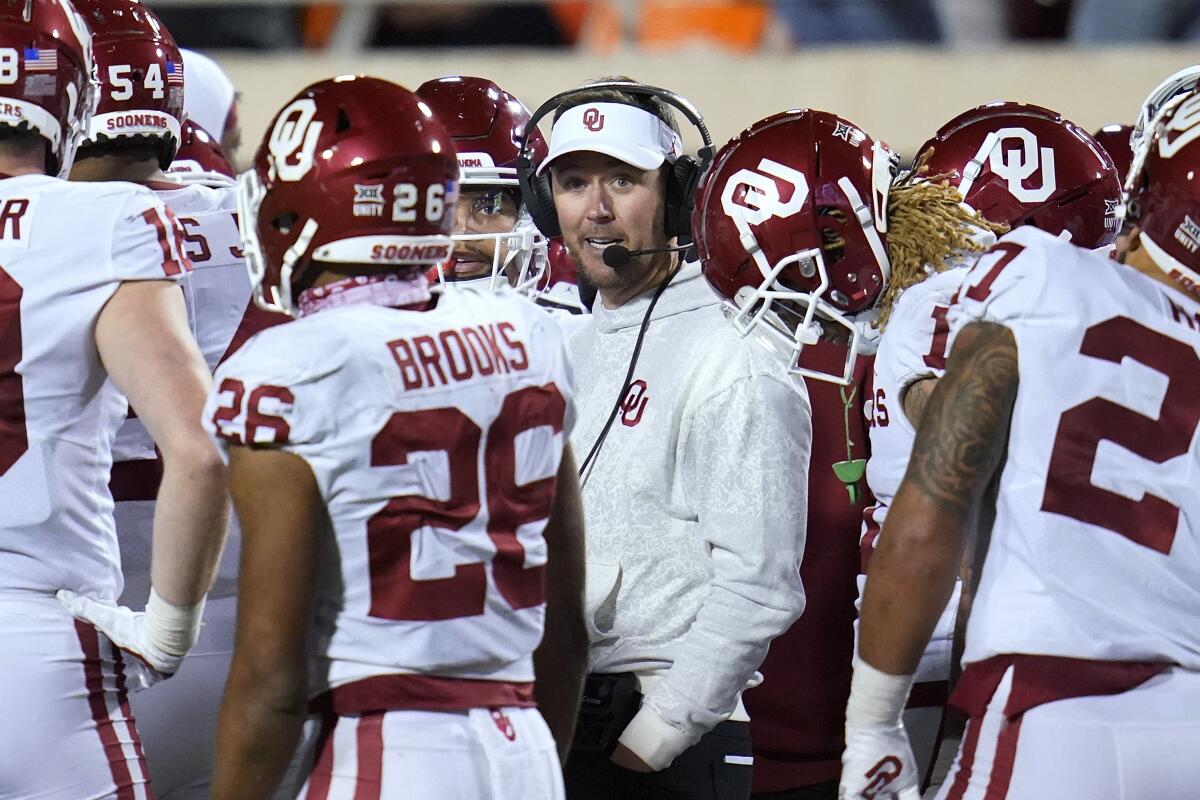 Oklahoma coach Lincoln Riley talks with his players during a game against Oklahoma State on Saturday.