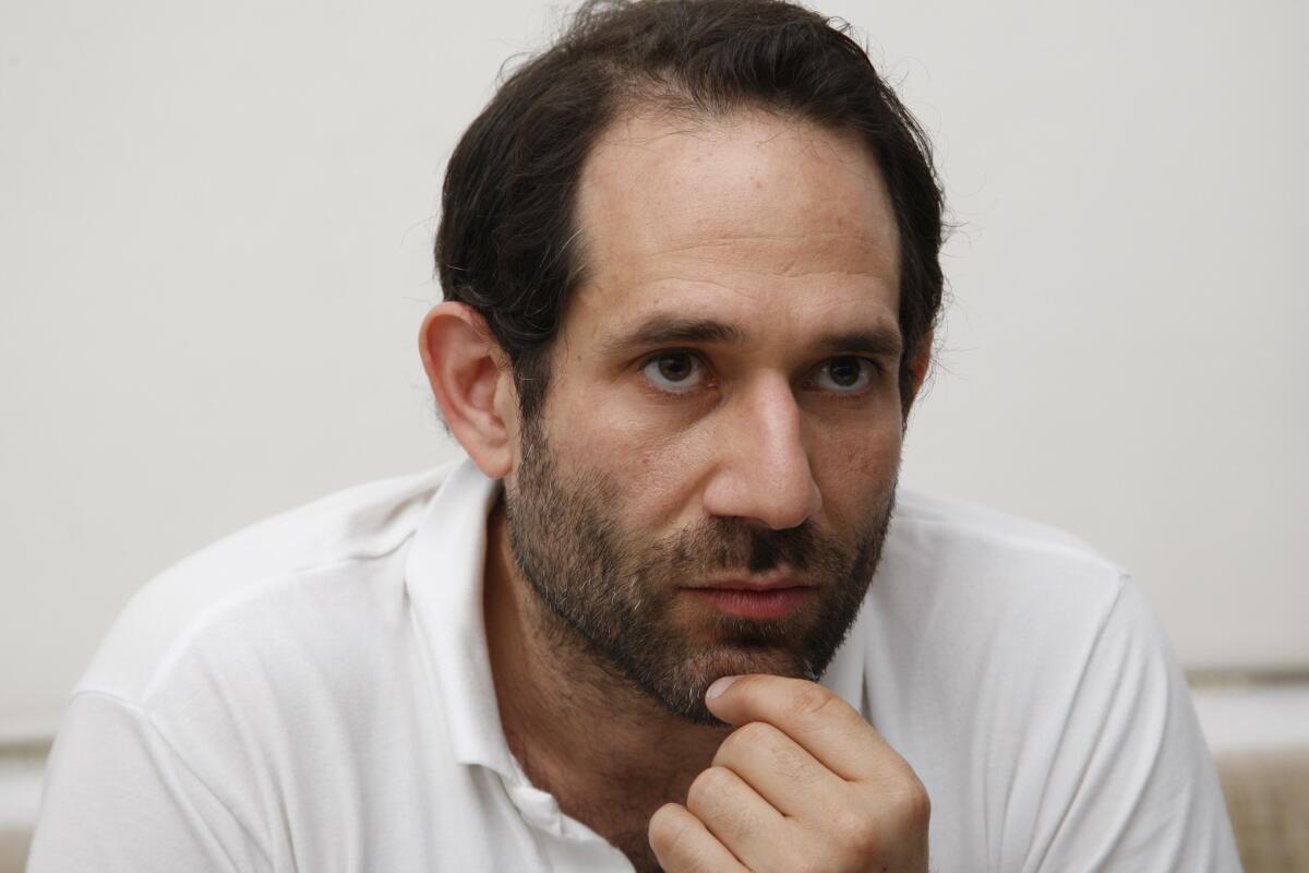 American Apparel was granted a temporary restraining order that will bar Dov Charney from disparaging the company and seeking to remove board members.