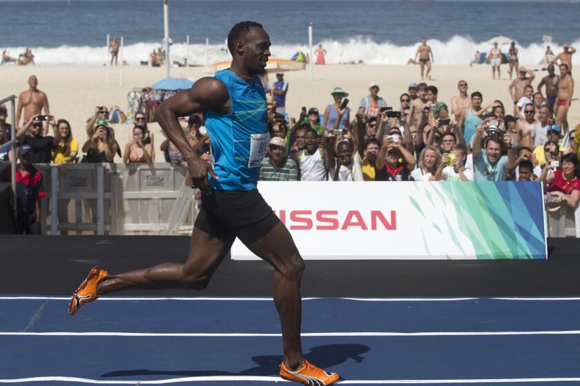Jamaican Olympic gold medalist Usain Bolt smiles after crossing the finish line of the "Mano a Mano" men's 100-meter challenge Aug. 17 in Rio de Janeiro, Brazil.
