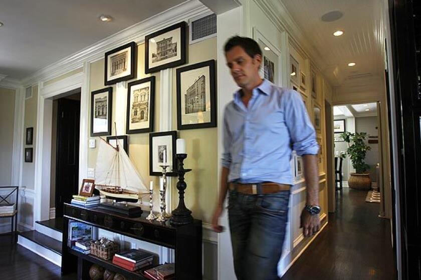 By David A. Keeps Interior designer Ryan Brown, known as the voice of reason on the Bravo reality series "Flipping Out," has made a living buying ugly duckling properties, turning them into beauties and selling them for profit. But as fans of "Flipping Out" know, Brown and his domestic partner, chef Dale Monchamp, had a daughter through a surrogate and wanted to put down roots. Two years ago they bought a 1942 two-story stucco house in the Hollywood Hills area of Los Angeles. Brown, shown here entering his living room, embarked on an extensive renovation that mixed Hollywood Regency, British Colonial, Asian-accented Modernism and nautical charm. Architectural images in black frames are hung on the wall and on top of molding, giving the gallery added dimension. The designer supplements black and white with a color scheme that also integrates browns, grays and other earth tones. "With a neutral palette you can bring any color in as an accent," he says. Back to L.A. at Home design blog