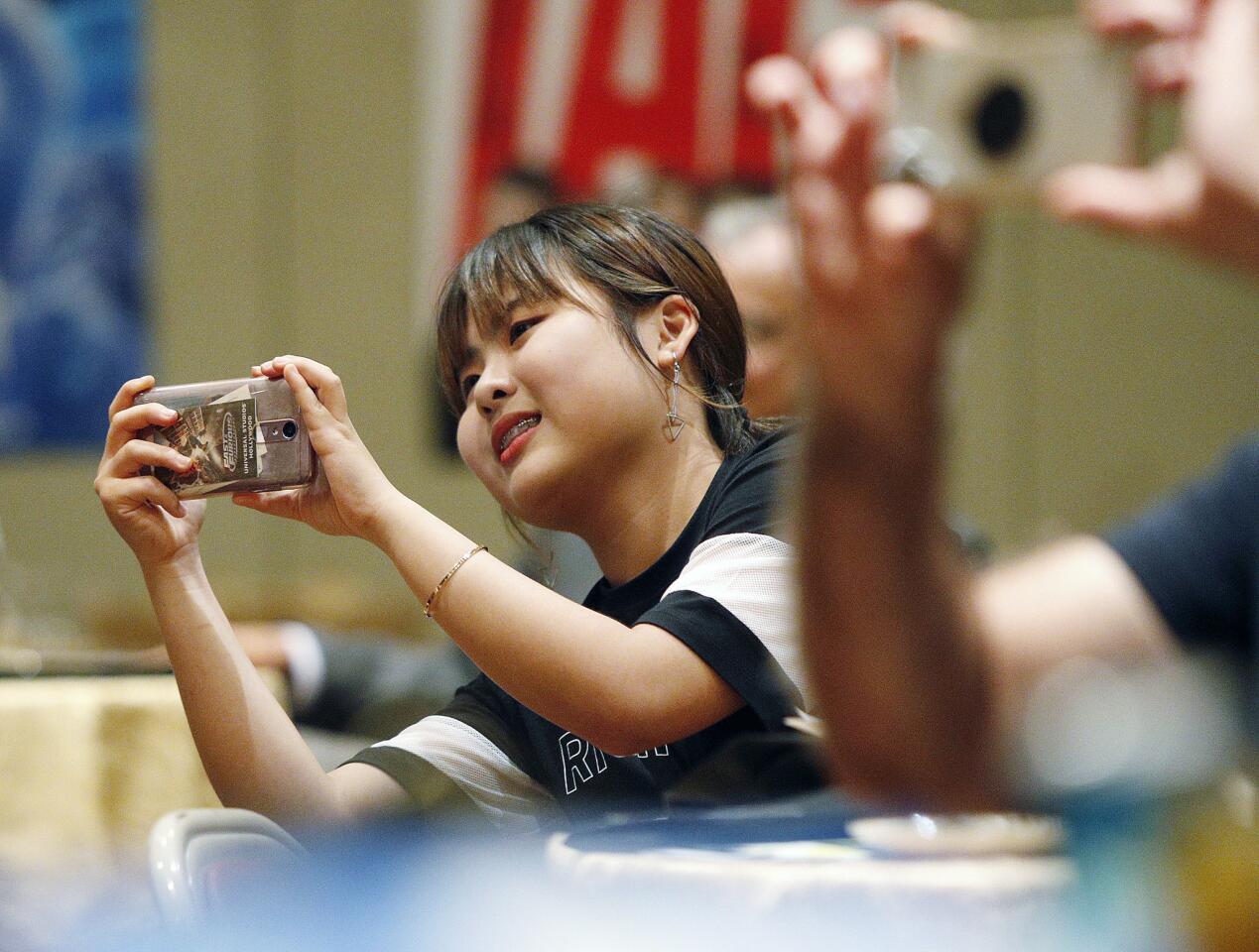 Korean student Uiju Han makes a cell phone video of the Burbank Students as they perform at a farewell dinner for a group of young Koreans visiting Burbank from Korea through a Sister City program at the Glendale First United Methodist Church in Glendale on Thursday, July 5, 2018. Burbank Students performed first, and the Korean students performed, playing piano, dancing, and singing K-Pop music.