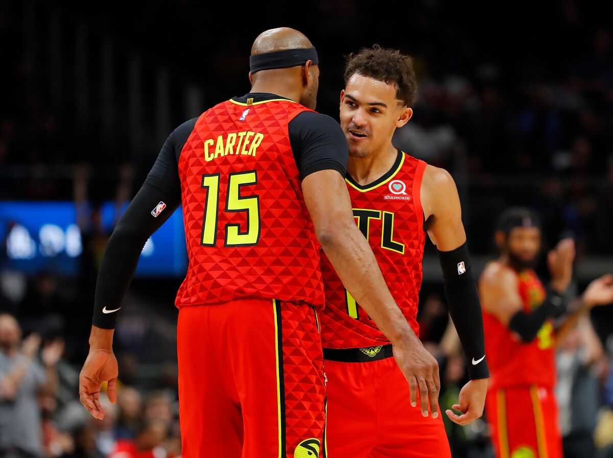 Vince Carter celebrates with his younger Hawks teammate Trae Young after a shot against the Spurs during a game Nov. 5.
