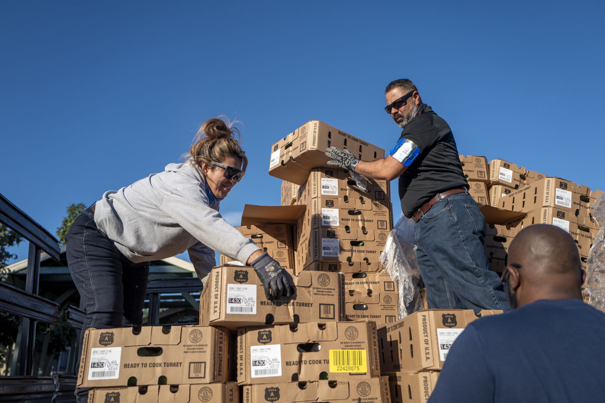 Volunteers unload turkeys from a flatbed truck.