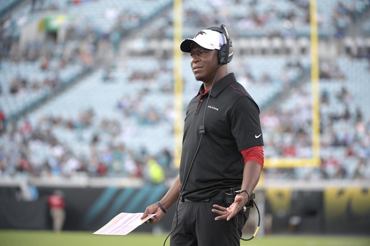 Falcons assistant head coach Raheem Morris watches from the sideline during a game.