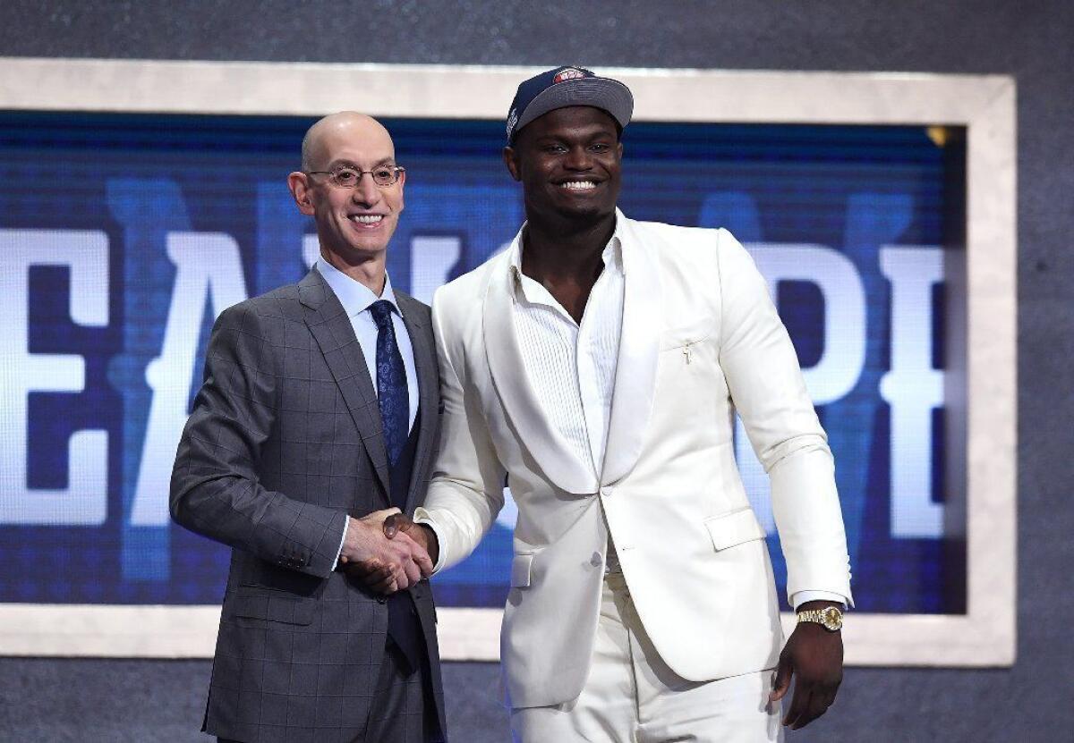 No. 1 overall pick Zion Williamson, right, with NBA Commissioner Adam Silver, wore all-white for his anointing as the sport's next great star.