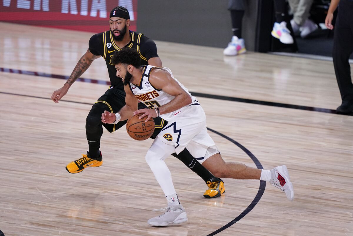 Nuggets guard Jamal Murray (27) drives Lakers forward Anthony Davis during Game 2.