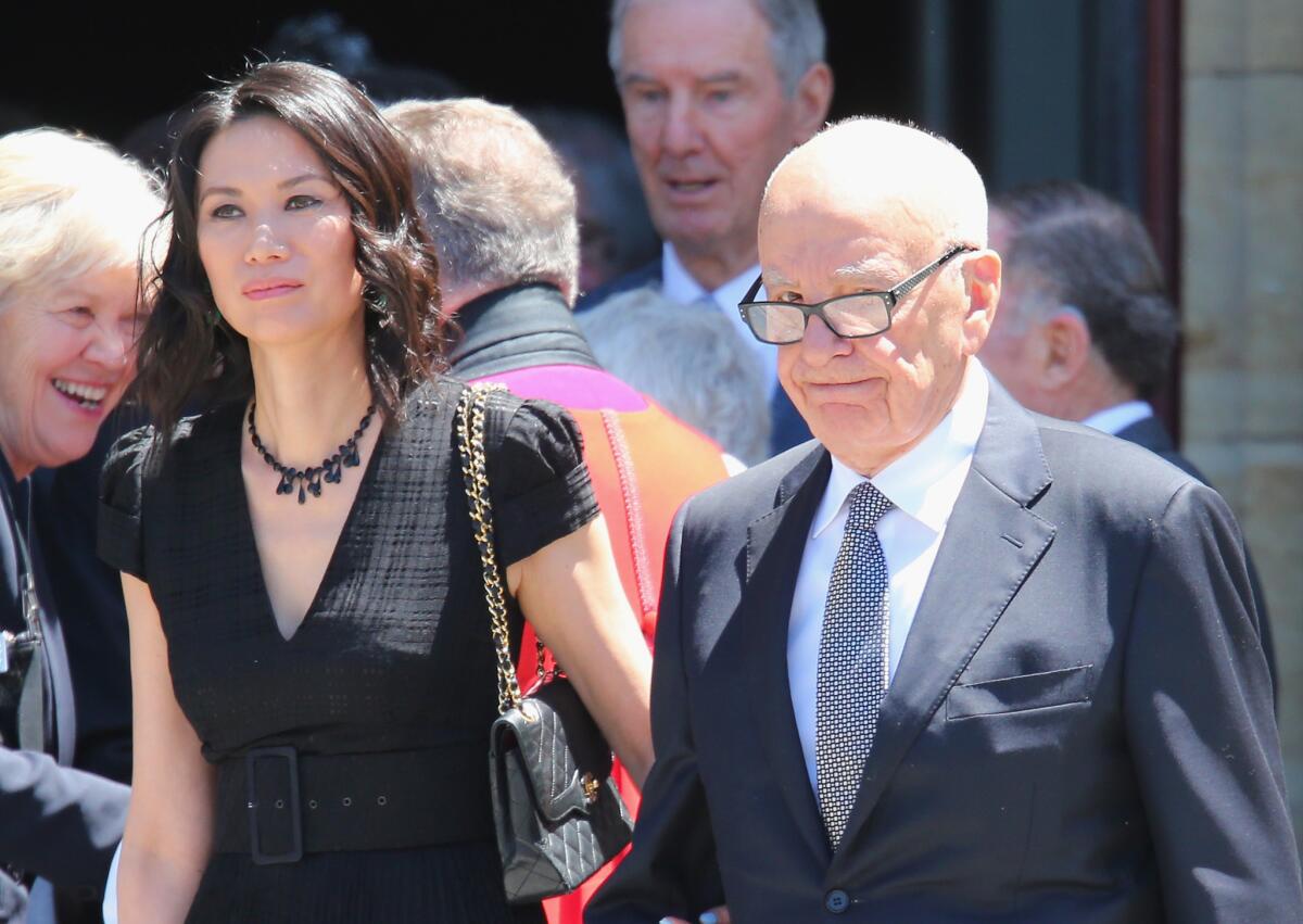 Rupert Murdoch and his wife Wendi Deng Murdoch leave after attending the Dame Elisabeth Murdoch public memorial at St Paul's Cathedral on December 2012 in Melbourne, Australia.