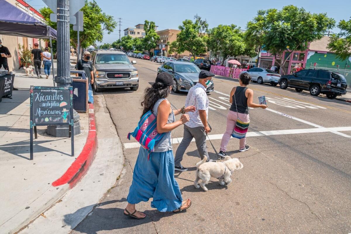 San Diegans walk around Barrio Logan during Walk The Block on Aug. 22, 2020