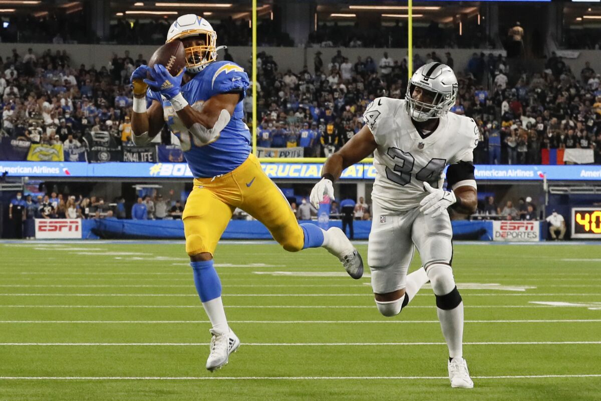 Chargers running back Austin Ekeler catches a touchdown pass over Las Vegas Raiders outside linebacker K.J. Wright.