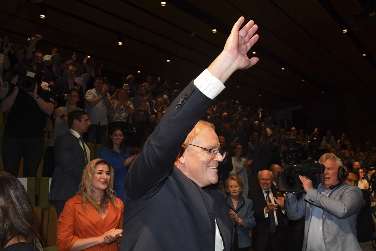 Australian Prime Minister Scott Morrison waves to party faithful during the Liberal Party campaign launch at the Brisbane Convention Centre in Brisbane, Australia, Sunday, May 15, 2022. (Mick Tsikas/AAP Image via AP)