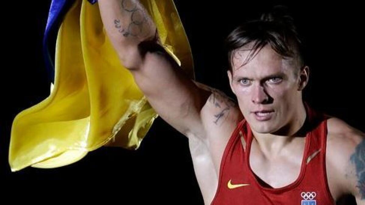 Ukraine's Oleksandr Usyk celebrates after winning a gold medal at the 2012 Summer Olympics in London.