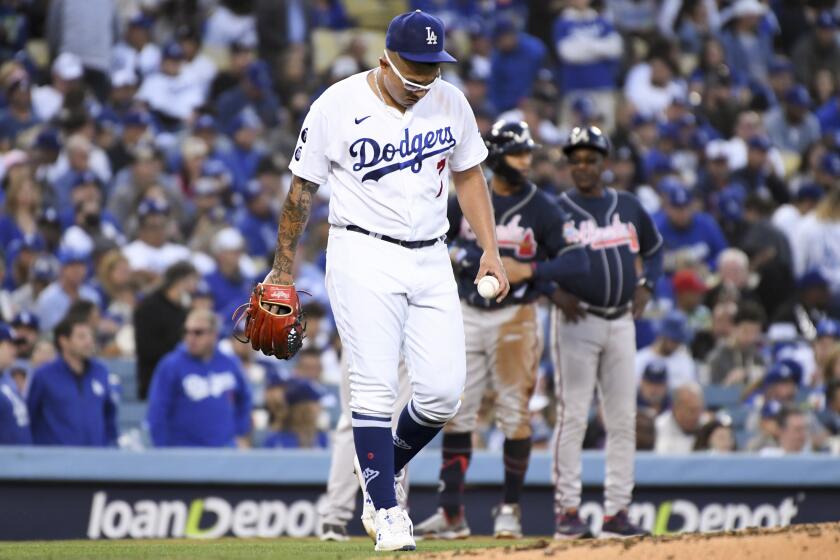 Los Angeles, CA - October 20: Los Angeles Dodgers starting pitcher Julio Urias reacts after allowing a triple to Atlanta Braves' Eddie Rosario during the third inning in game four in the 2021 National League Championship Series at Dodger Stadium on Wednesday, Oct. 20, 2021 in Los Angeles, CA. (Wally Skalij / Los Angeles Times)