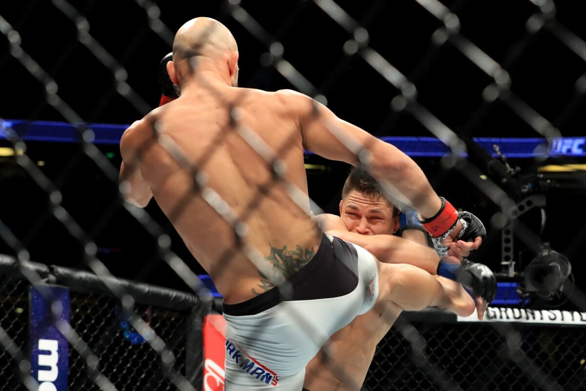 Joshua Berkman attempts to kick Drew Dober during their flyweight bout at UFC 214.