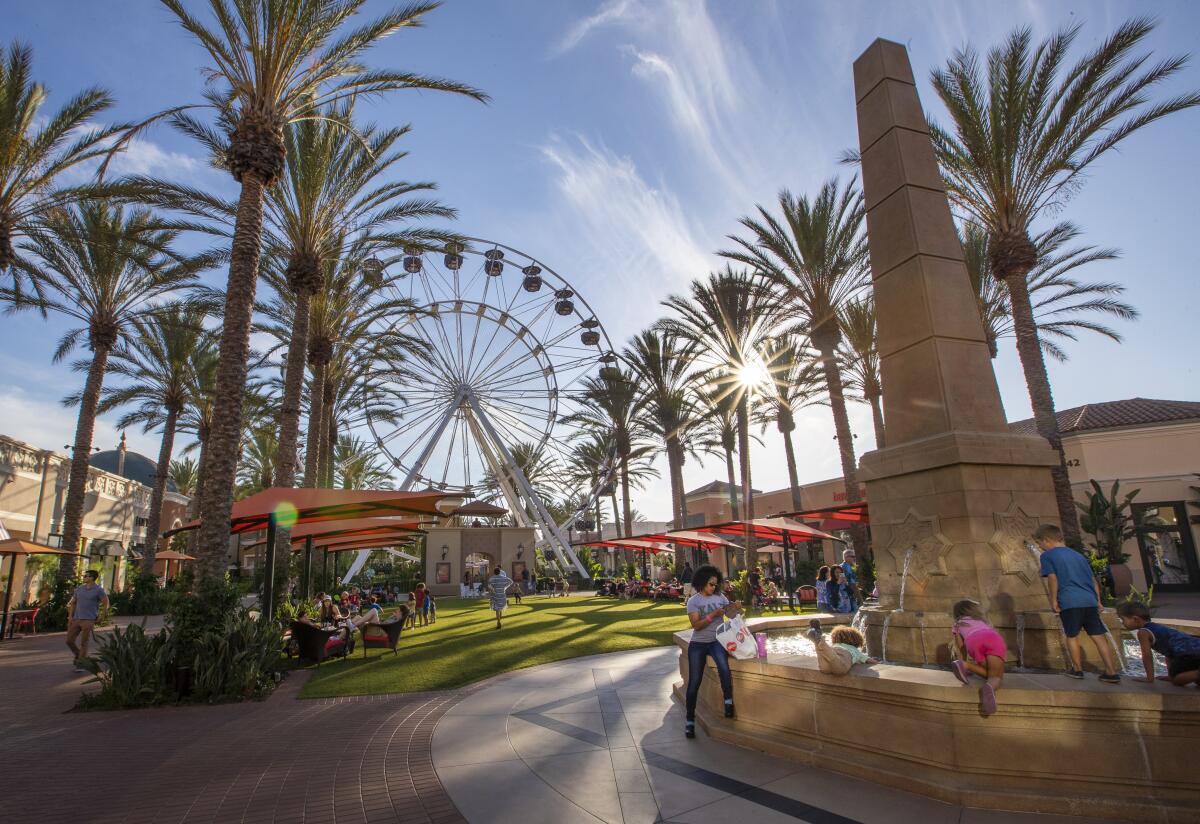 People mill about at The Irvine Sprectrum outdoor mall.