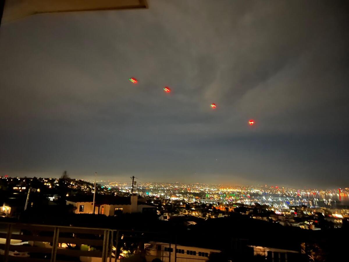 Four helicopters fly over Point Loma the night of Feb. 2. The Army has been conducting training in the area the past week.