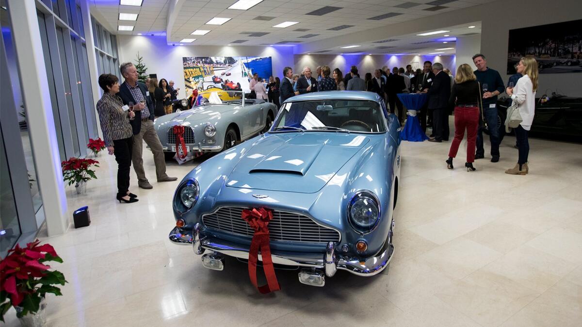 Guests view an Aston Martin DB5 during the grand opening of Morris & Welford on Dec. 7.