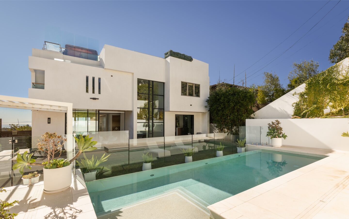 Modern and boxy, the three-story home has a pool next to it