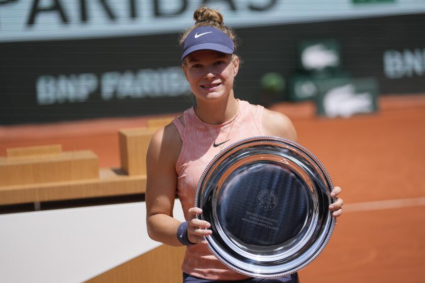 Netherlands' Diede de Groot holds the trophy after winning against China's Zhang Zhizhen in the women's wheelchair final match of the French Open tennis tournament at the Roland Garros stadium in Paris, France, Saturday, June 8, 2024. (AP Photo/Thibault Camus)