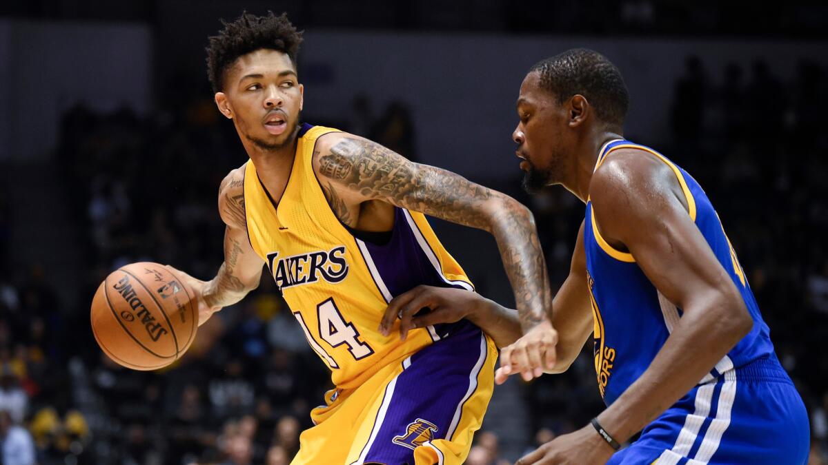 Los Angeles Lakers forward Brandon Ingram tries to drive past the defense of Golden State Warriors forward Kevin Durant during an NBA preseason game Wednesday.