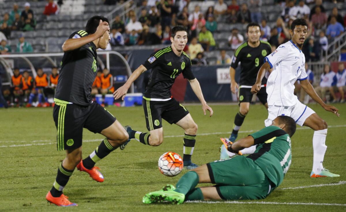 Mexico forward Alfonso Tamay, front left, has his shot stopped by Honduras goalie Harold Fonseca, front right, as, from back left, Mexico forwards Marco Bueno and Erick Torres cover with Honduras defender Marcelo Pereira during the second half of a CONCACAF Olympic qualifying soccer match Wednesday, Oct. 7, 2015, in Commerce City, Colo. Mexico won 2-1. (AP Photo/David Zalubowski)