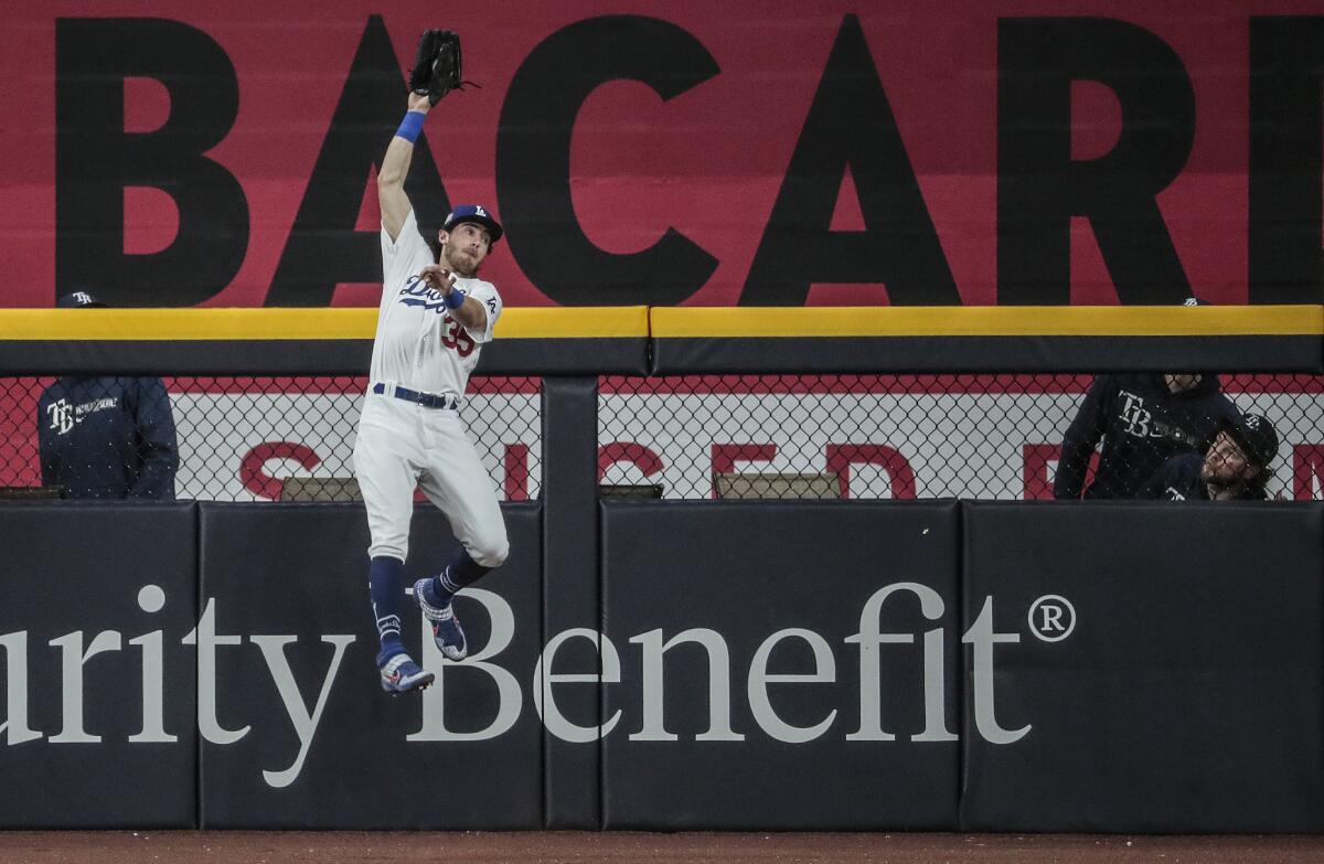 Dodgers center fielder Cody Bellinger steals a home run from Tampa Bay's Austin Meadows.