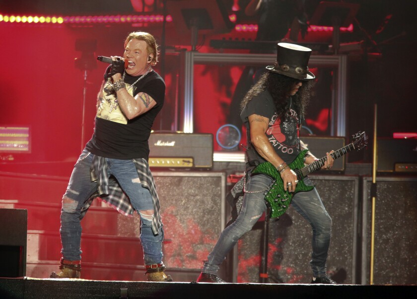 FILE - Guns N' Roses' Axl Rose, left, and Slash perform on the first weekend of the Austin City Limits Music Festival on Oct. 4, 2019, in Austin, Texas. The hard rock band has booked two dates at the Hard Rock casino in Atlantic City, N.J., Sept. 11 and 12. (Photo by Jack Plunkett/Invision/AP)