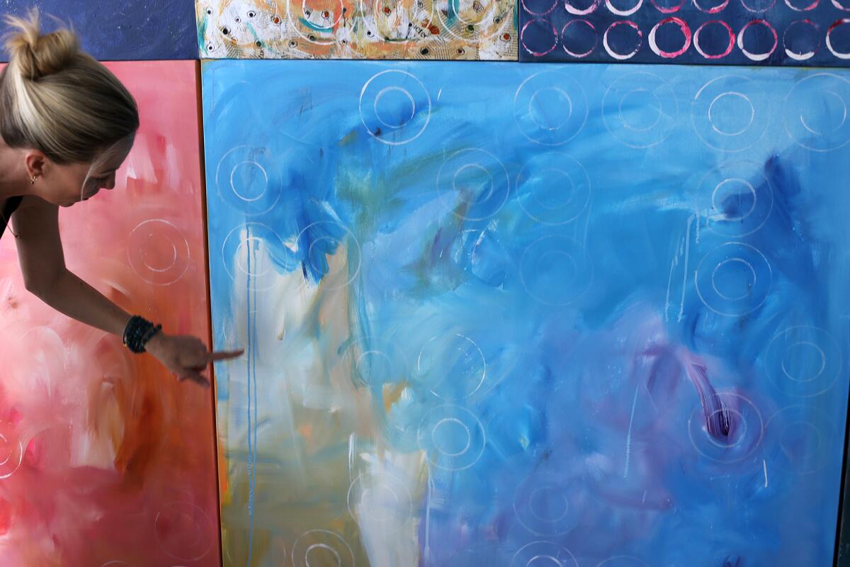 Artist Britt Michaelian explains her painting process at her home in Newport Beach.
