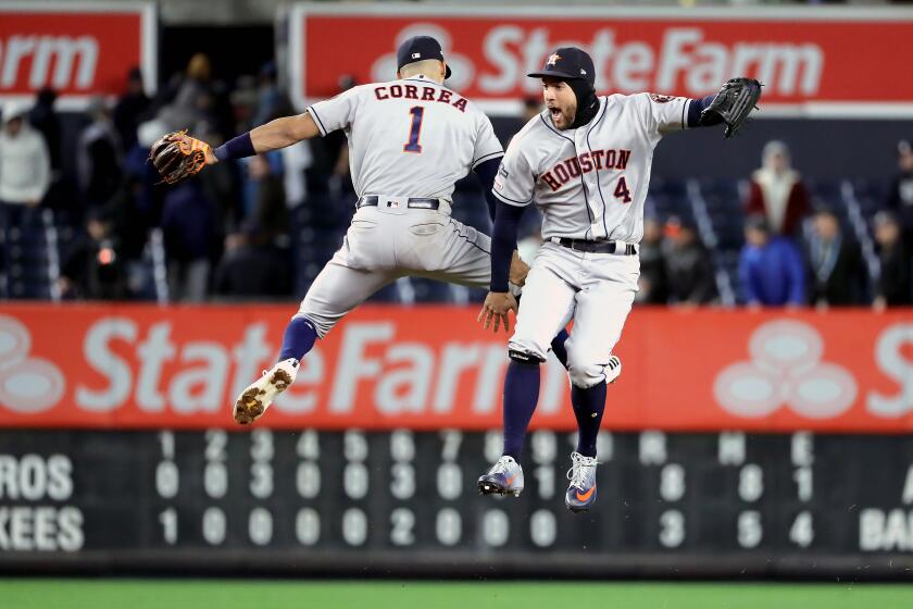 NEW YORK, NEW YORK - OCTOBER 17: Carlos Correa #1 and George Springer #4 of the Houston Astros celebrate their teams 8-3 win over the New York Yankees in game four of the American League Championship Series at Yankee Stadium on October 17, 2019 in New York City. (Photo by Elsa/Getty Images) *** BESTPIX *** ** OUTS - ELSENT, FPG, CM - OUTS * NM, PH, VA if sourced by CT, LA or MoD **