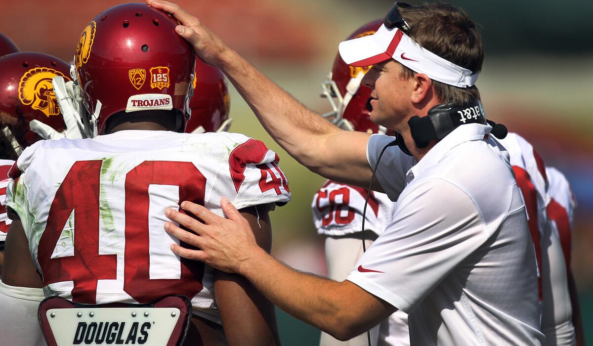 USC defensive coordinator Justin Wilcox gives a pat to linebacker Jabari Ruffin (40) during the spring game.