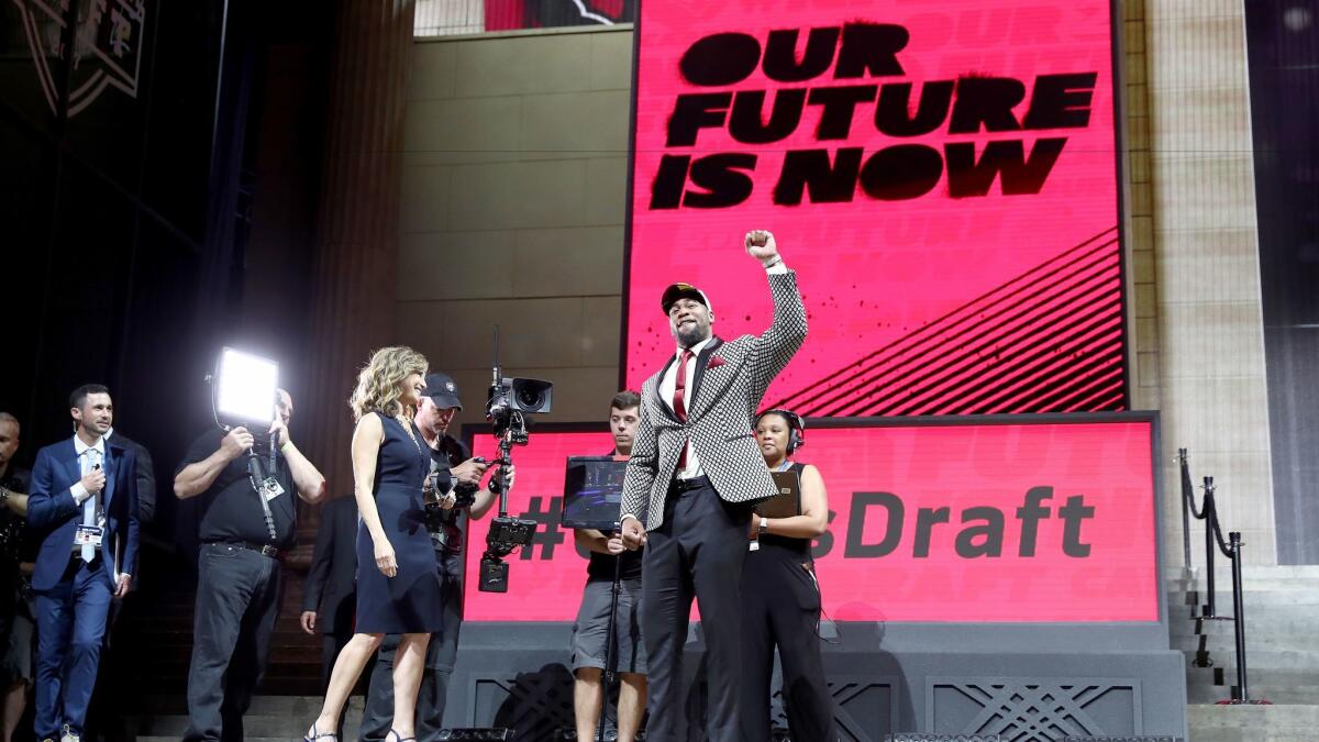 Linebacker Haason Reddick raises his fist in front of the Philadelphia crowd after getting drafted 13th overall by the Cardinals. (Elsa Garrison / Getty Images)