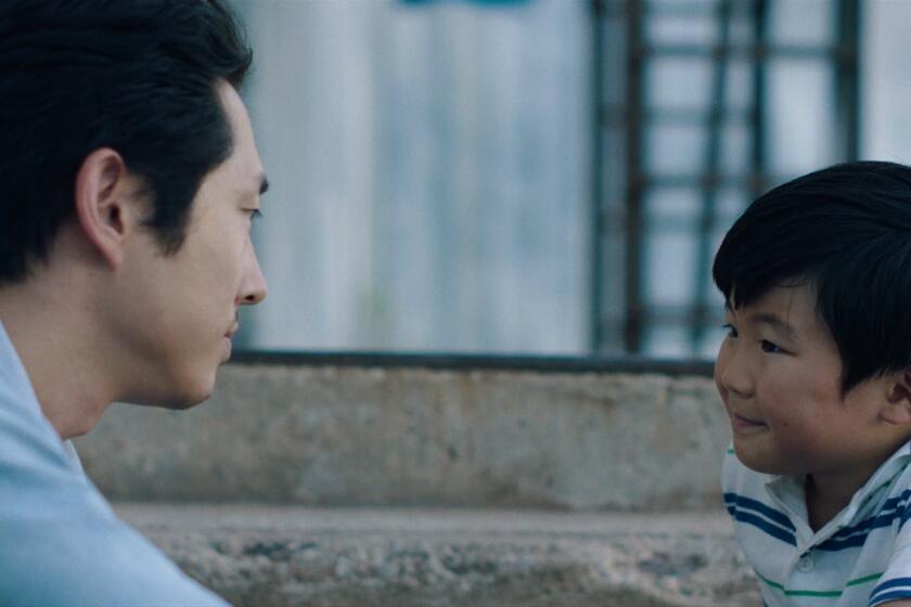 Steven Yeun and Alan S. Kim in "Minari" from A24. Director Lee Isaac Chung Credit: Courtesy of A24