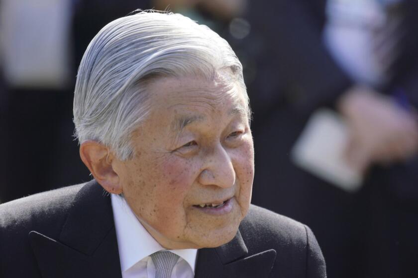 FILE - In this Wednesday, April 25, 2018 file photo, Japan's Emperor Akihito greets the guests during the spring garden party at the Akasaka Palace imperial garden in Tokyo. Japan's Emperor Akihito, marking his 85th birthday  his last before his upcoming abdication  said he feels relieved that his reign is coming to an end without having seen his country at war and that it is important to keep telling younger people about his nation's wartime history, it was reported on Saturday, Dec. 22, 2018. (AP Photo/Eugene Hoshiko, File)