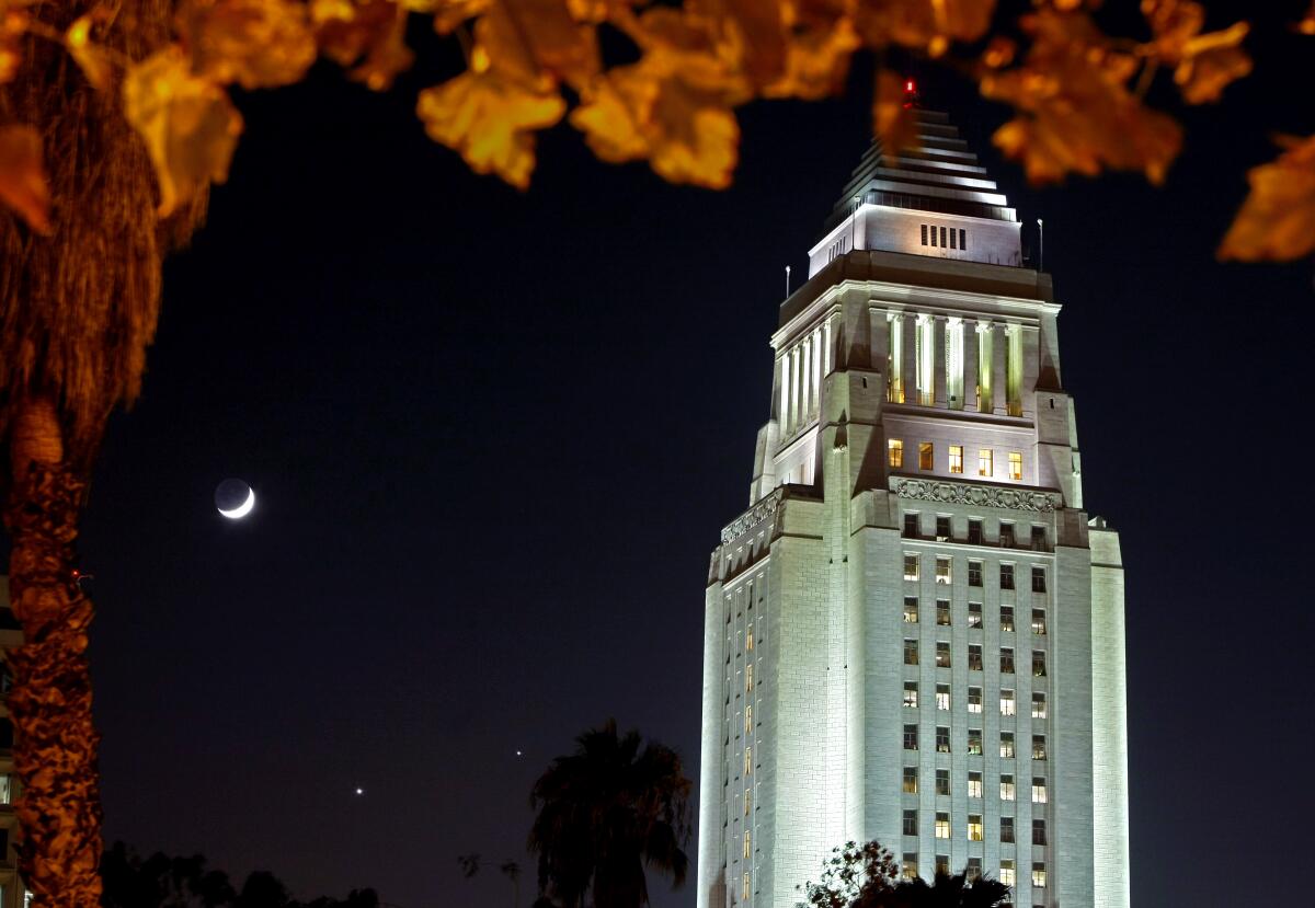 Los Angeles City Hall is lighted up at night 