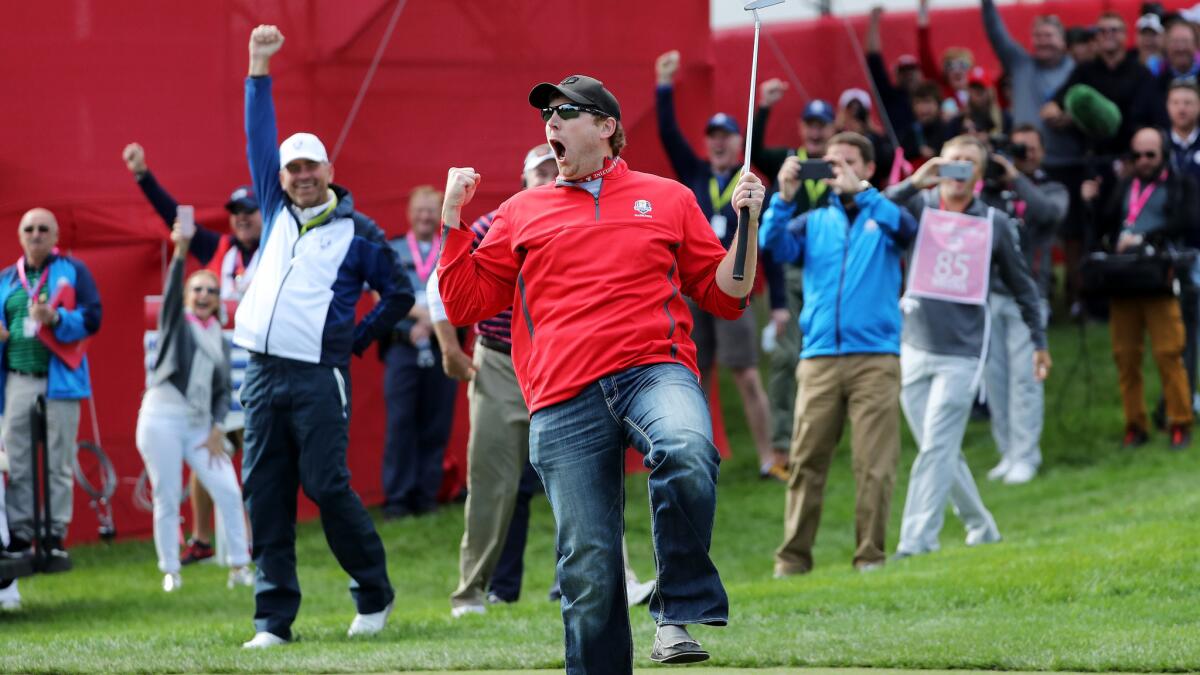 American golf fan David Johnson reacts after sinking a putt during Ryder Cup practice on Thursday.