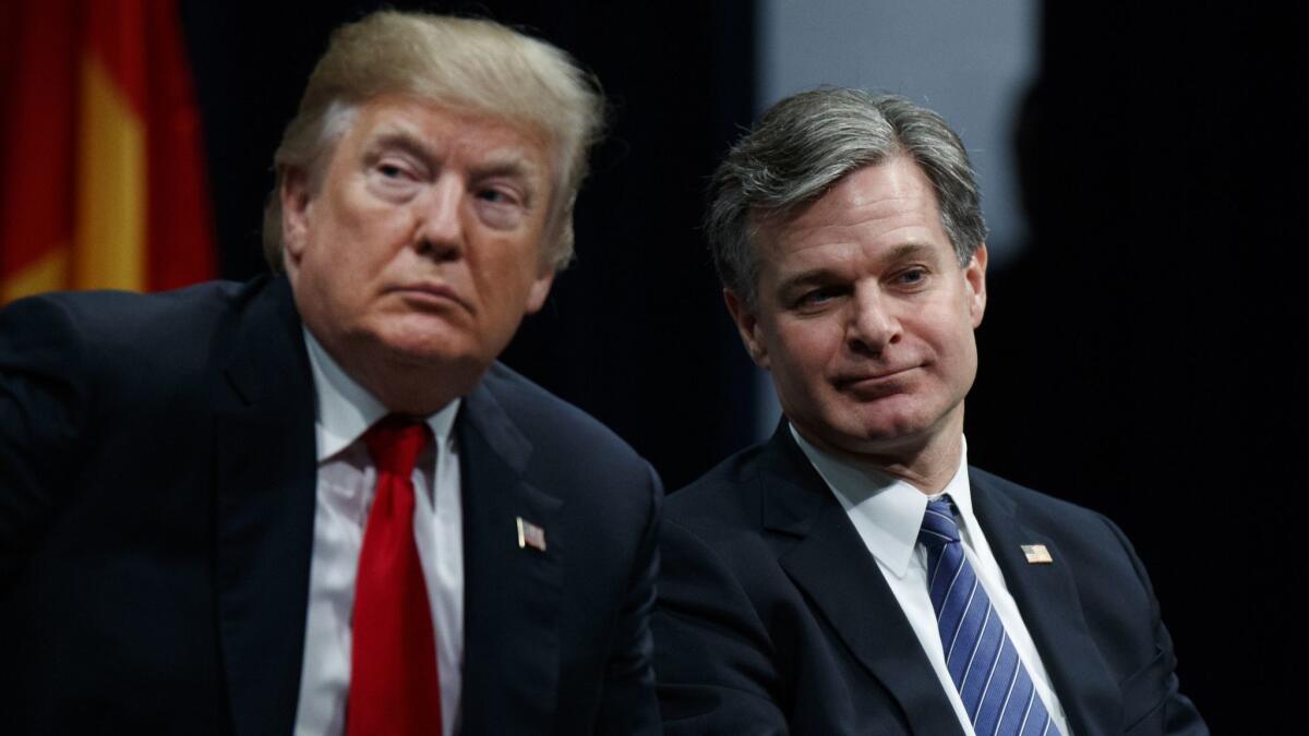 President Trump sits with FBI Director Christopher A. Wray during an FBI National Academy graduation ceremony.