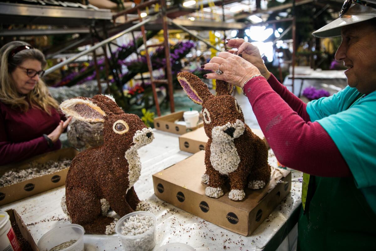 Volunteers work on Rose Parade float decorations in Irwindale.