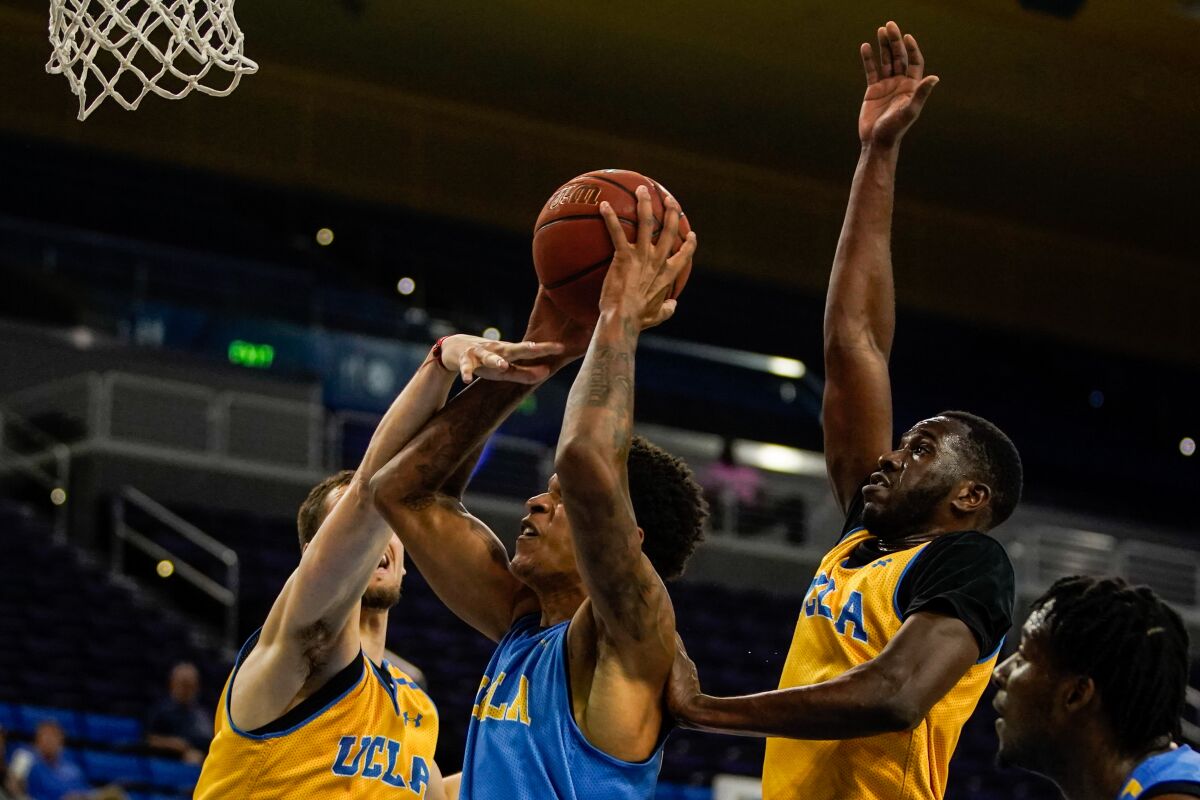 UCLA's Shareef O'Neal (22) goes is defended against during a preseason showcase at Pauley Pavilion on Wednesday in Westwood.